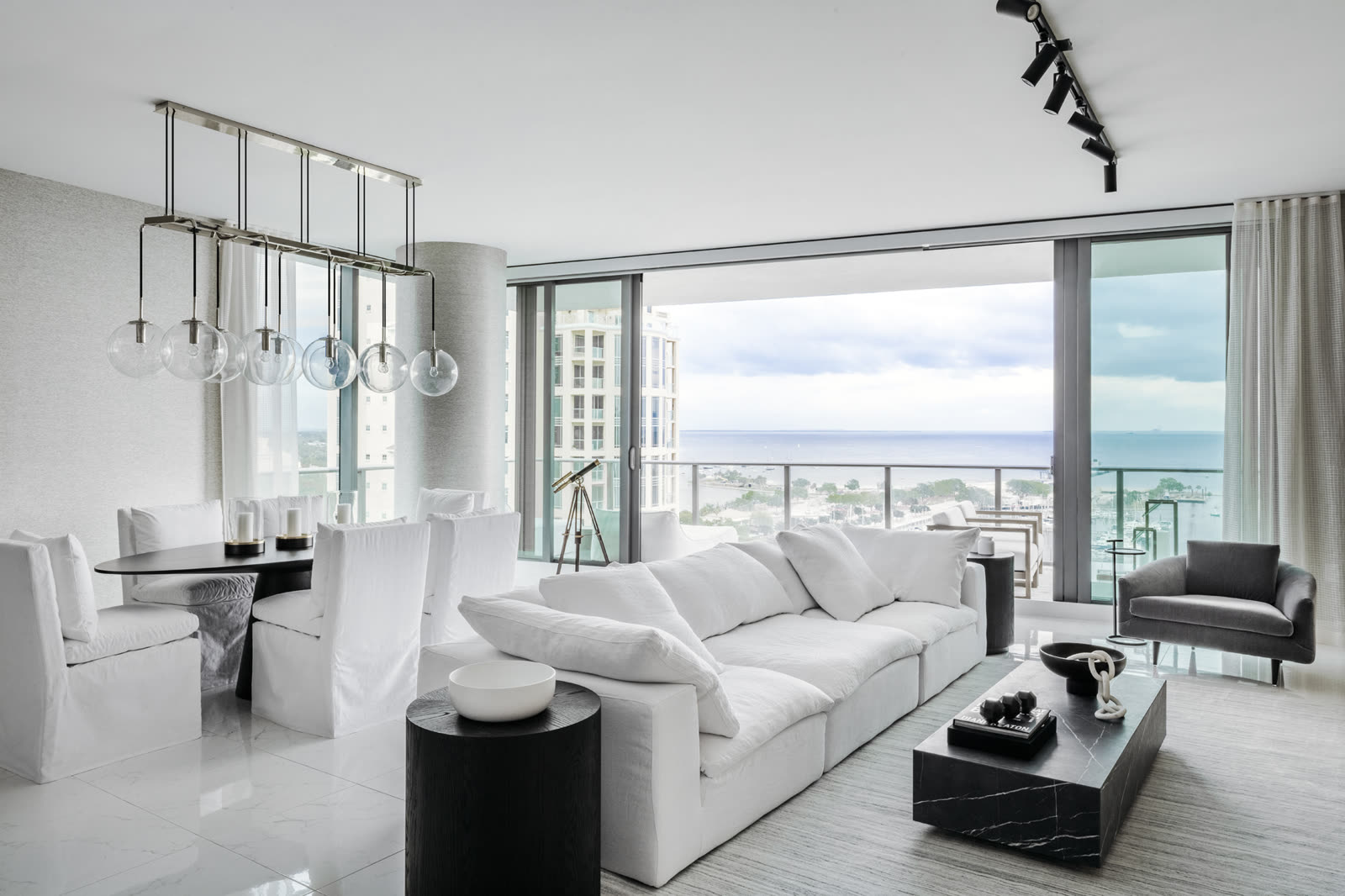 AB Residence waterfront living and dining room by Sixth Sense Studio in St. Petersburg