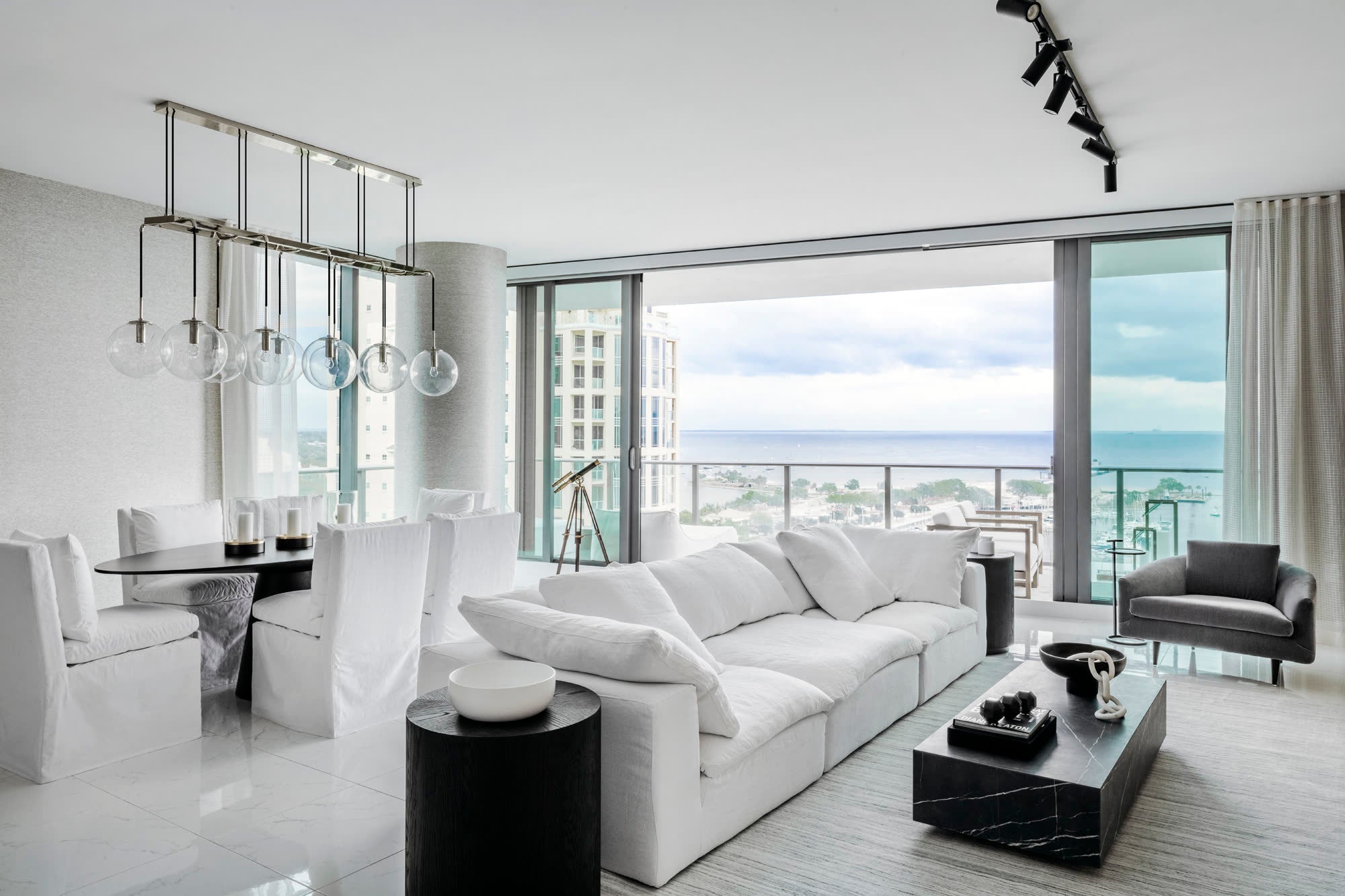 Waterfront living and dining room designed by Sixth Sense Studio in St. Petersburg