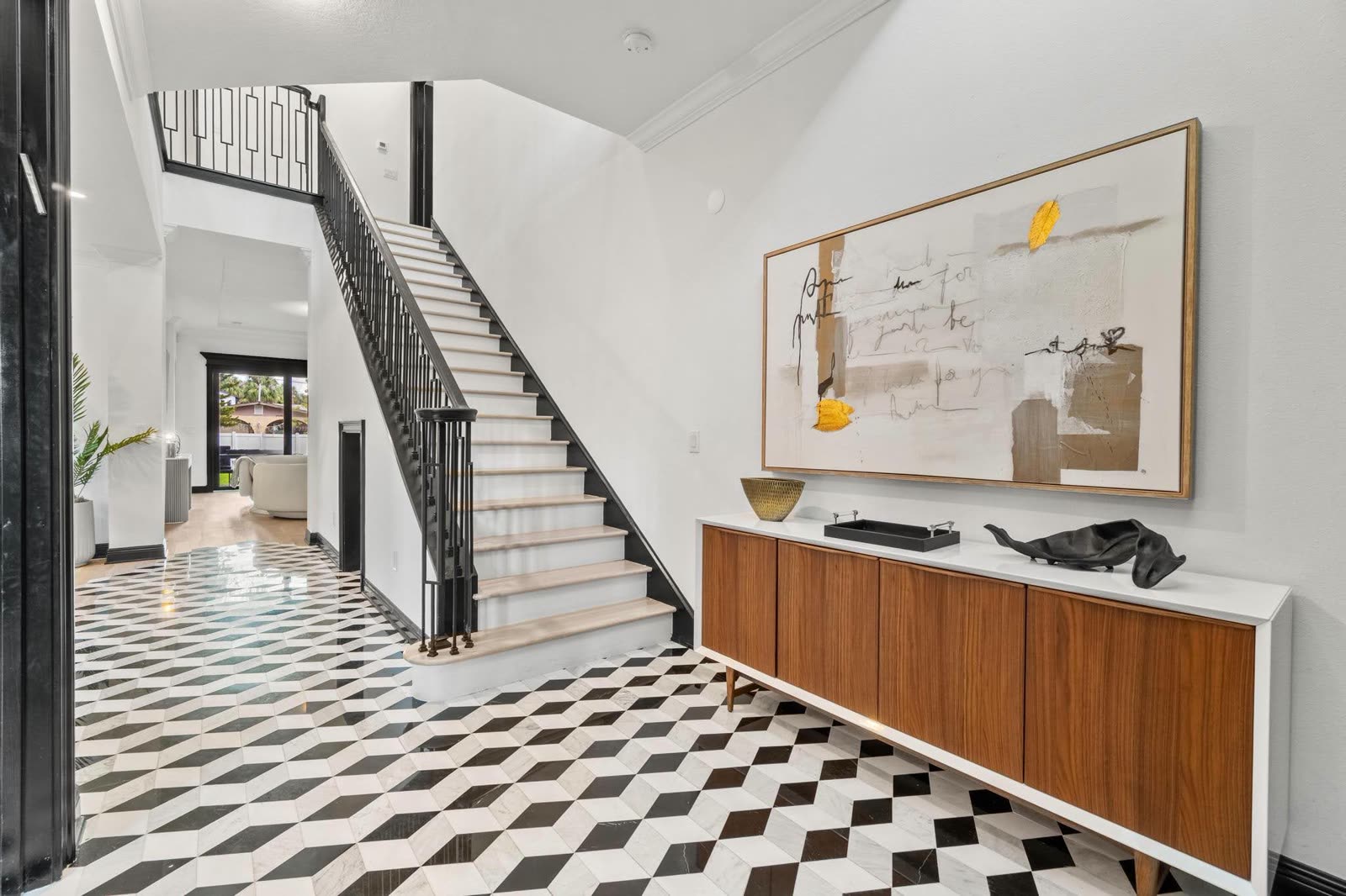 MV Residence entry hall with checkerboard floor and staircase in Tampa